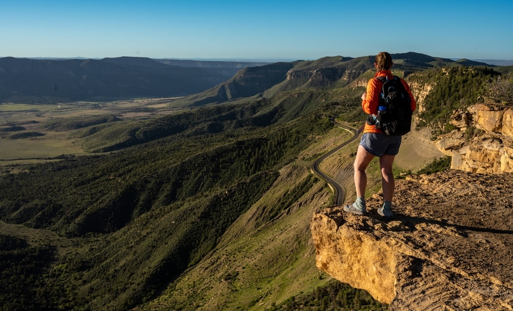 A hiker enjoying an overlook at Mesa Verde National Park near Durango